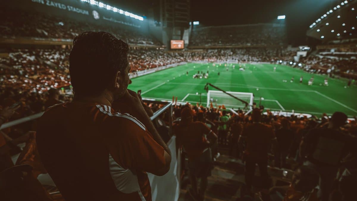 Fans cheering during a thrilling night football match at Mohamed Bin Zayed Stadium, Abu Dhabi.