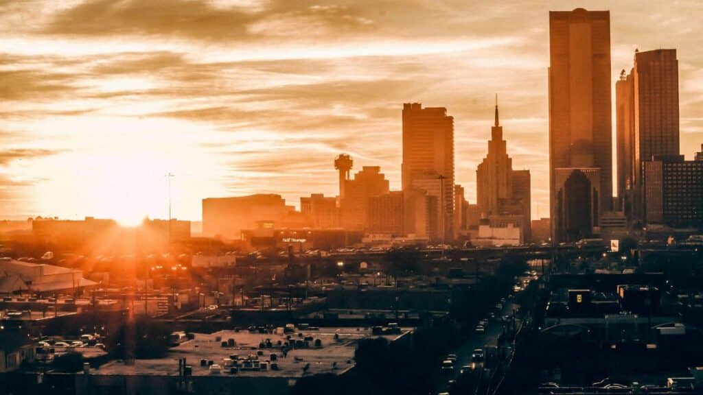 Stunning Dallas skyline at sunset, showcasing vibrant colors and iconic architecture.