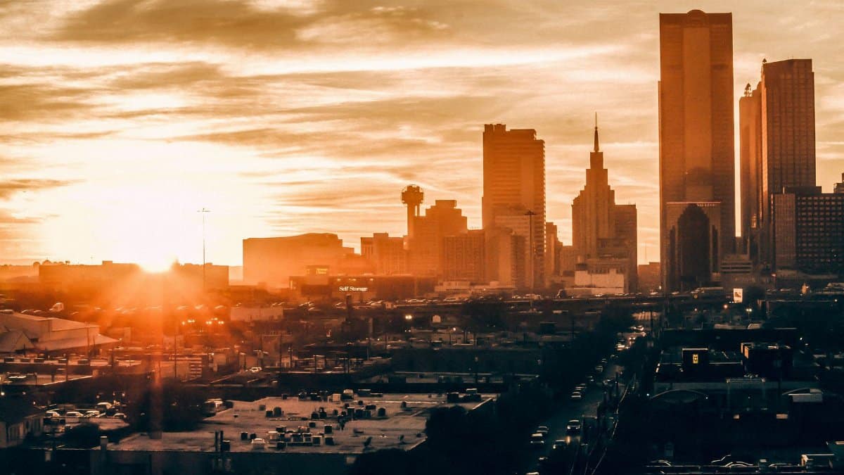 Stunning Dallas skyline at sunset, showcasing vibrant colors and iconic architecture.