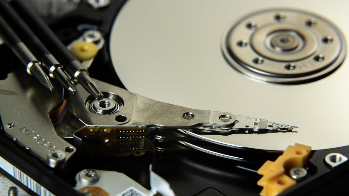 Detailed view of internal hard drive platters and read/write heads for data storage technology.