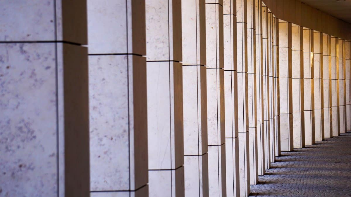 Elegant stone colonnade casting shadows in Feldkirch, Austria.