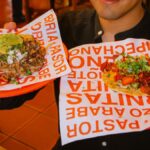 Two delicious tacos with vibrant garnishes in San Pedro Cholula, Puebla, showcasing Mexican street food culture.