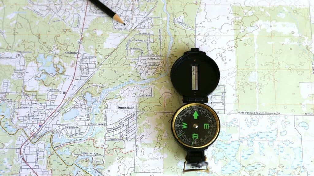A detailed topographic map of Dunnellon, Florida with a compass and pencil.