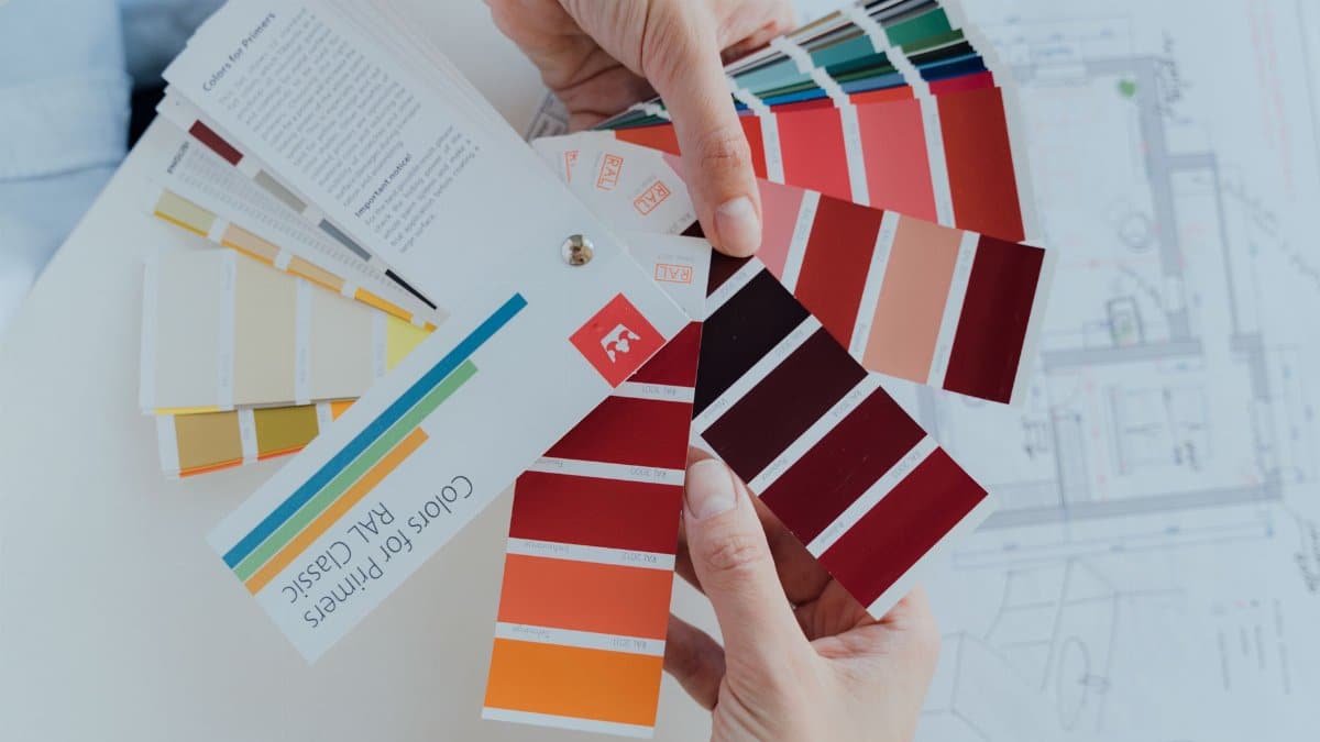 Person choosing color palettes for interior design projects, emphasizing creative choices.