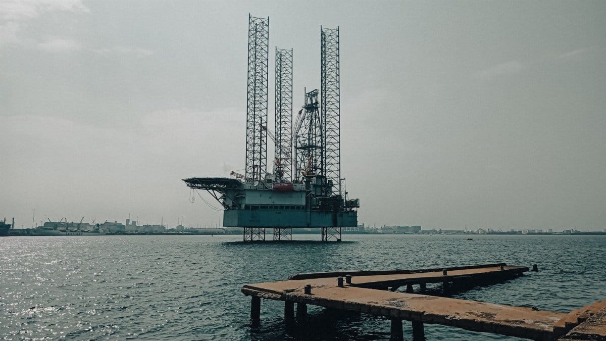 Offshore oil platform in urban harbor, showcasing industrial scenery and oceanic platform structure.