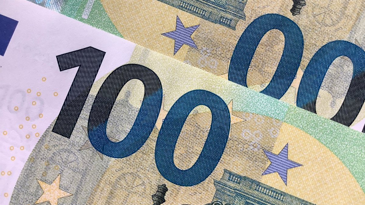 Detailed view of overlapping 100 Euro banknotes showcasing intricate design details.