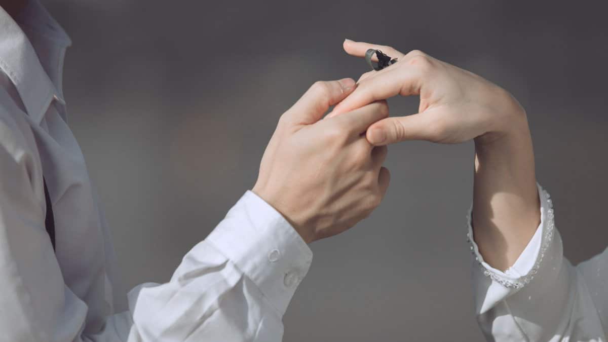 Close-up of a romantic proposal with a couple exchanging an engagement ring. Intimate and special moment.