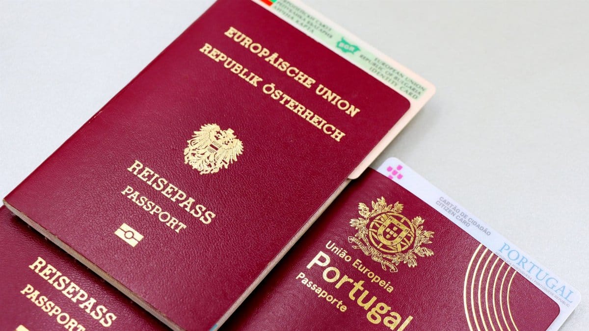 A close-up image of Austrian and Portuguese passports with a Bulgarian ID card.