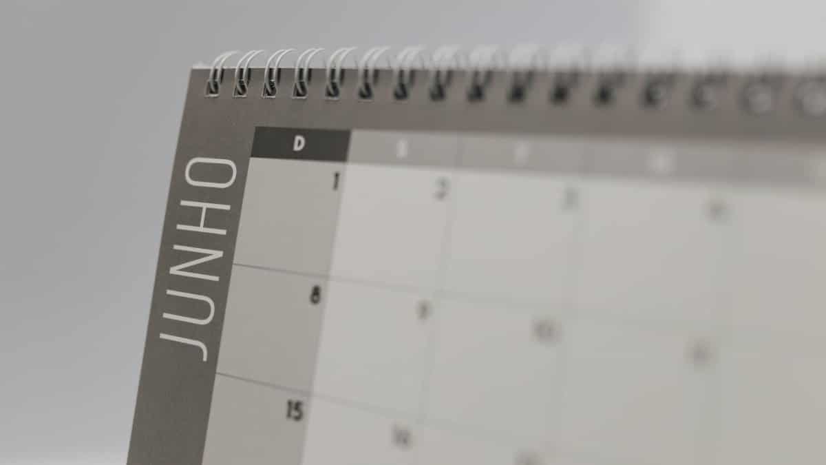 A detailed shot of a June calendar page with spiral binding, featuring Portuguese text.