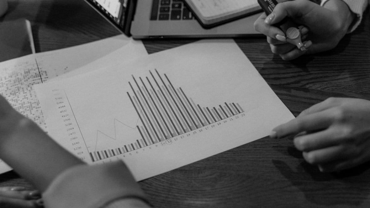 Close-up view of colleagues discussing business reports in a creative office setting.