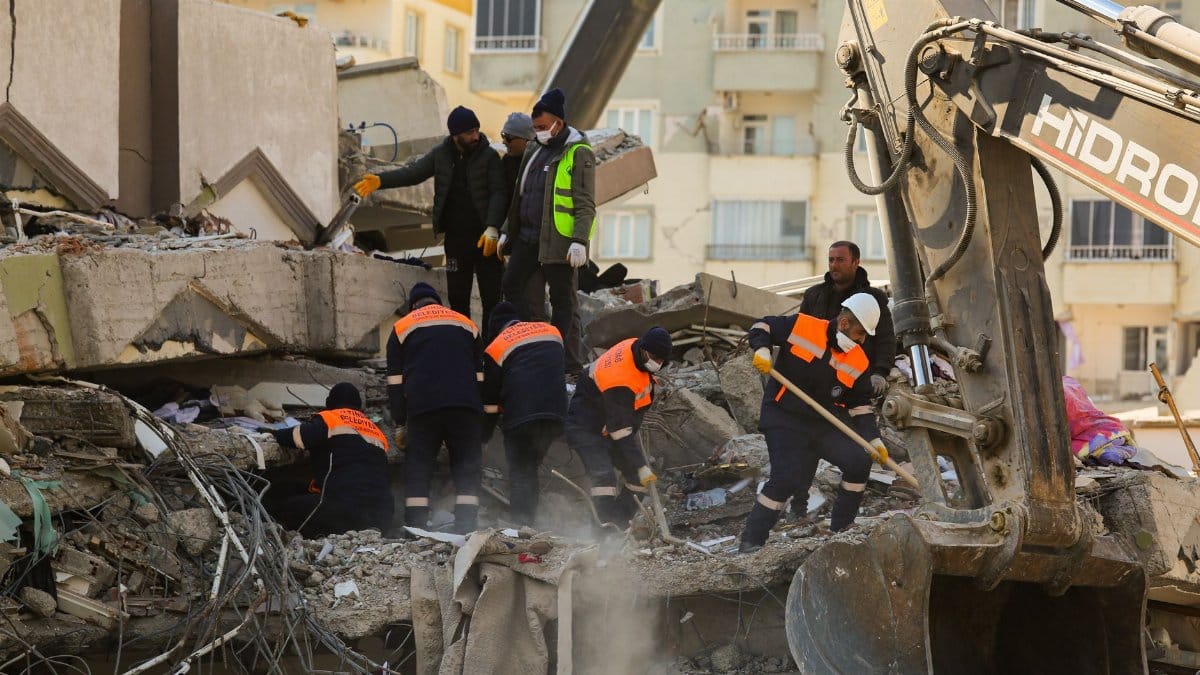 Rescue team in action amidst the rubble of a collapsed building. Urban disaster recovery scene.
