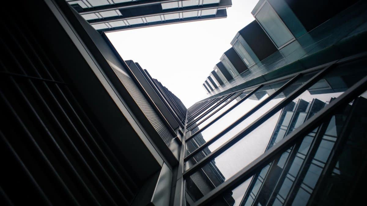 Dynamic urban architecture captured through a low angle perspective of modern glass skyscrapers.