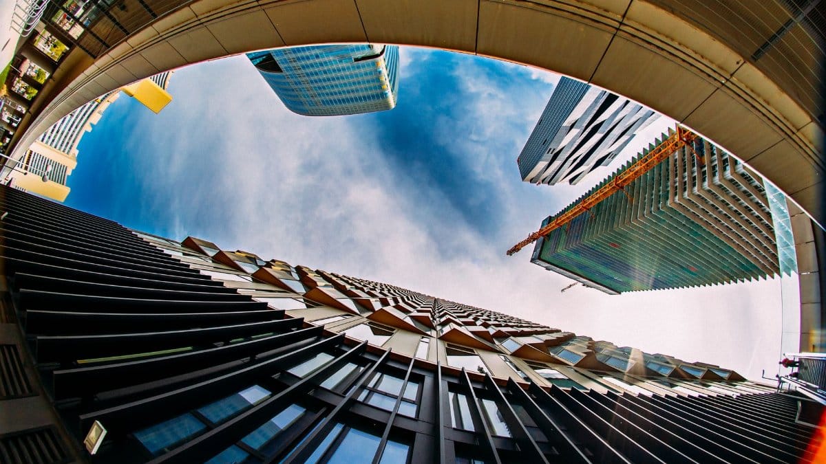 Fisheye perspective capturing modern architecture and skyscrapers in Vienna, Austria.