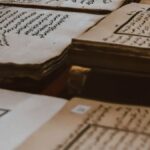 A collection of ancient manuscripts featuring Arabic script, showcasing historical texts on aged paper.