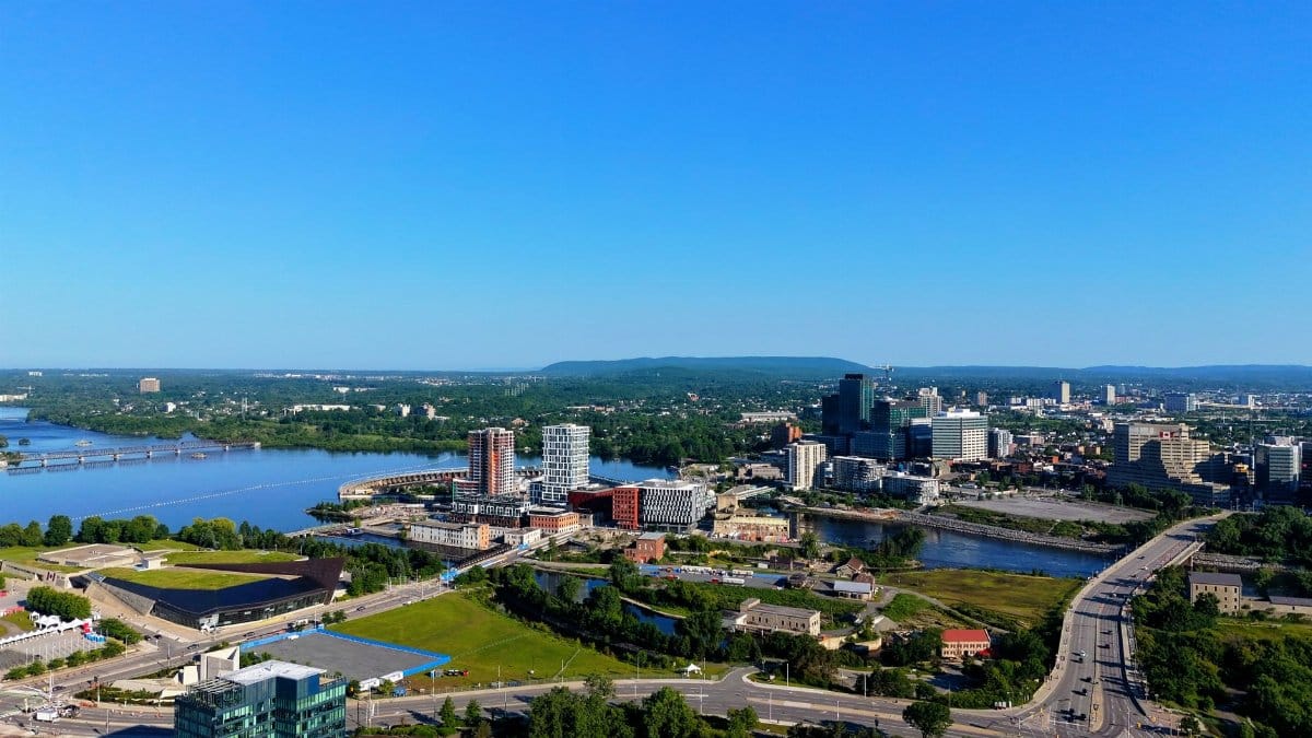 Aerial view of urban cityscape with river and modern buildings in Ottawa.