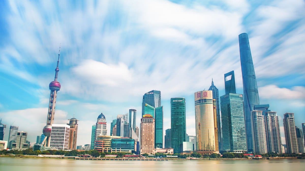 Vibrant view of Shanghai's skyline along the Huangpu River, featuring iconic skyscrapers.
