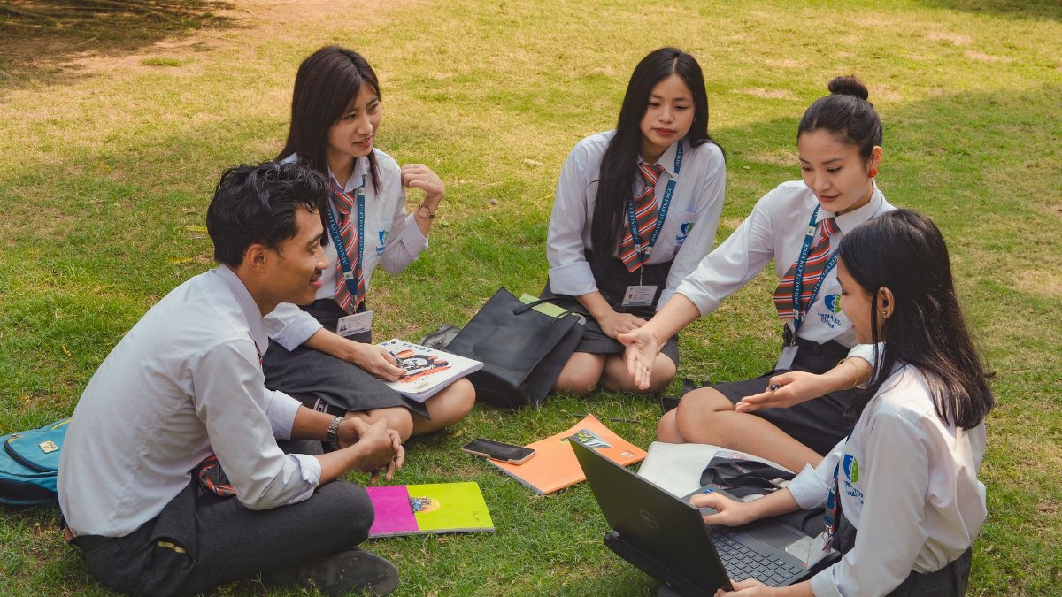 A group of college students studying together on a sunny day in Dimapur, India.