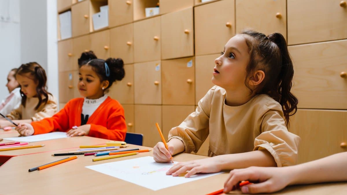 Children participating in a creative classroom writing session indoors. Education and learning environment.