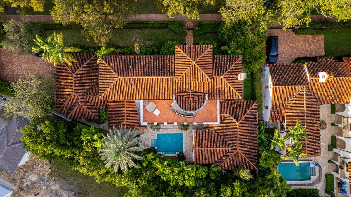 An aerial shot of a luxury home in Miami featuring a pool and lush greenery.