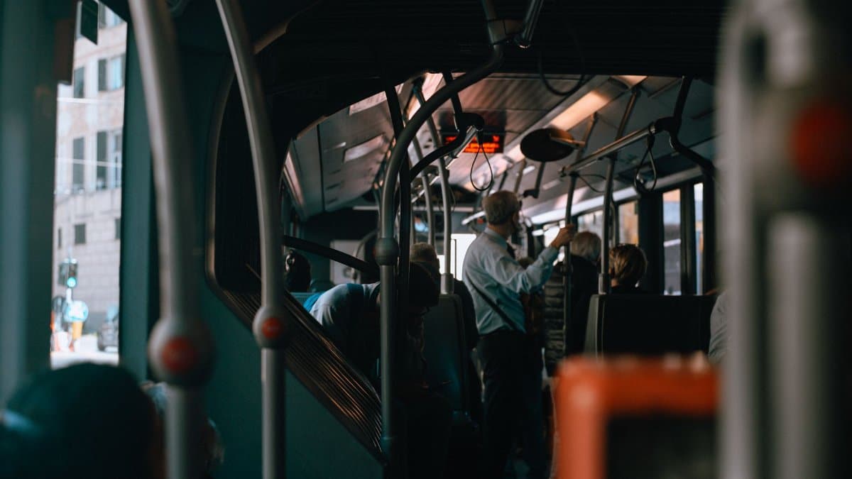 Inside view of a Genoa city bus during a bustling commute, capturing everyday life in Italy.