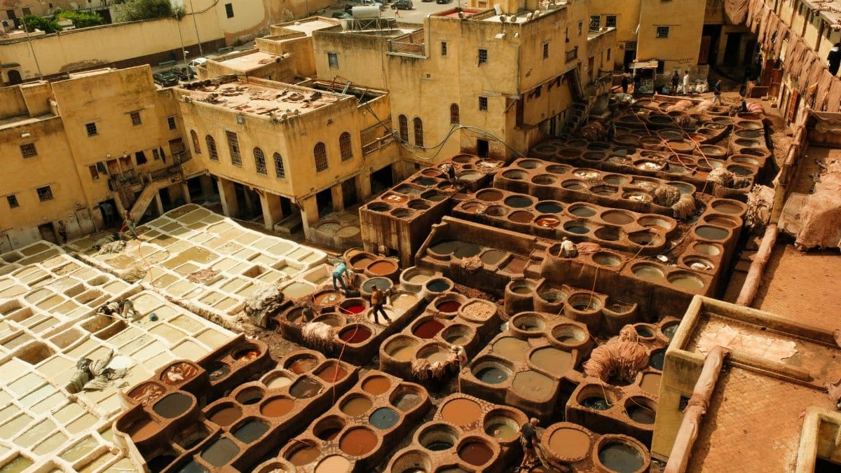 Aerial view of the historic leather tannery in Fes, Morocco, showcasing traditional dyeing vats.