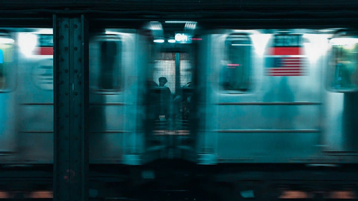 Dynamic view of a New York subway train with motion blur effect, capturing urban transit energy.