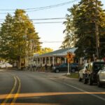 Cozy street view in Holland, Michigan showcasing parked cars, trees, and clear evening light.