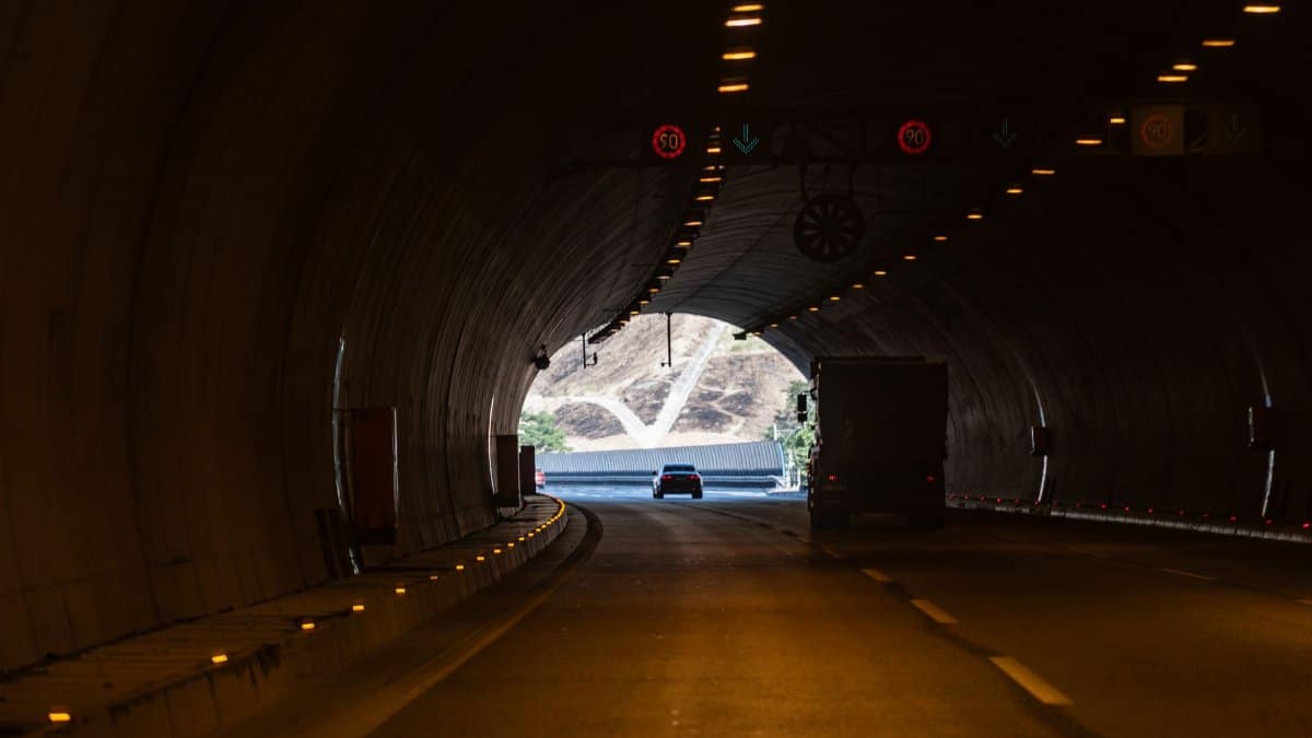 Vehicles driving through a tunnel in İzmir, Türkiye, with natural light at the exit.