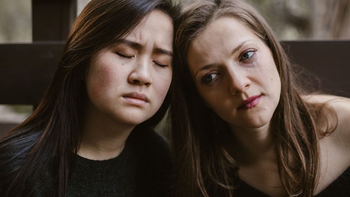 Two women in a soothing embrace, expressing empathy and friendship.