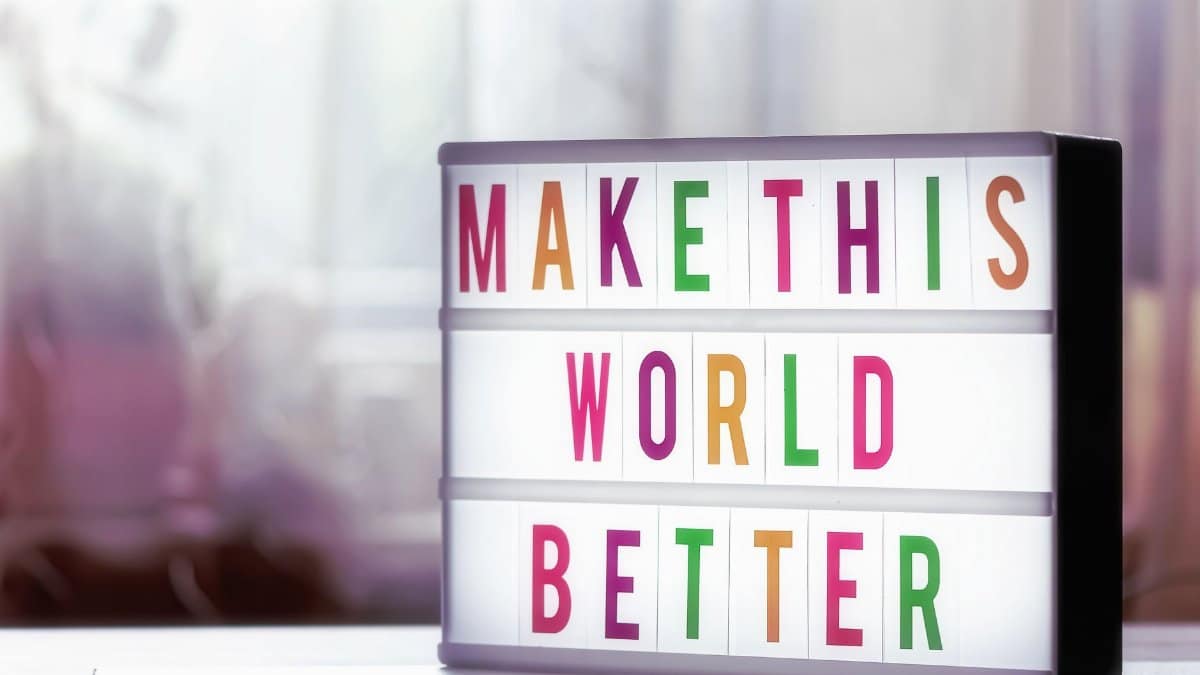 Motivational lightbox with the message 'Make This World Better' against a soft blurred background.