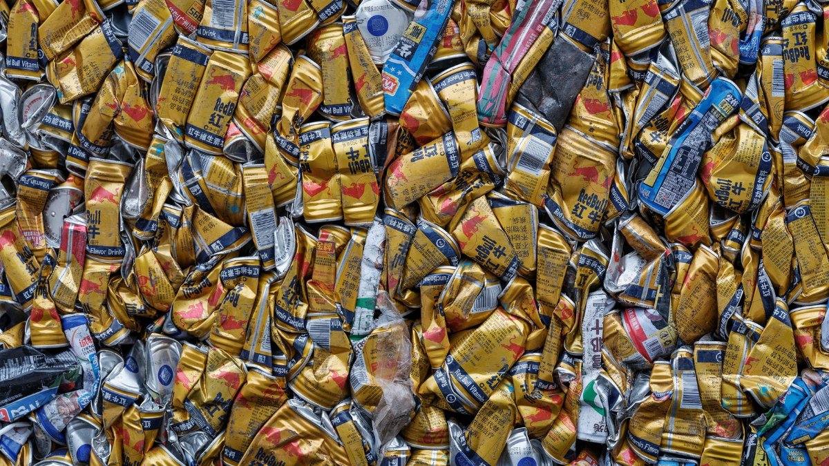 A pile of crushed beverage cans, highlighting recycling and environmental awareness.