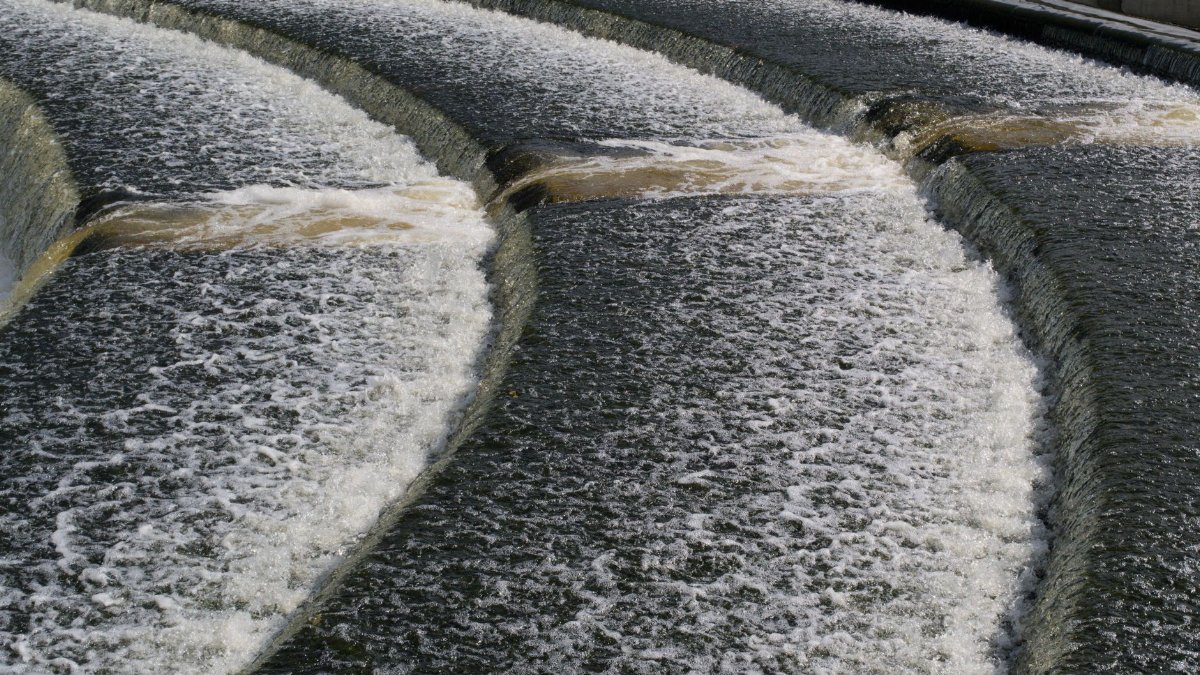 Dynamic view of a cascading waterfall over concrete steps in Lisburn, Northern Ireland.