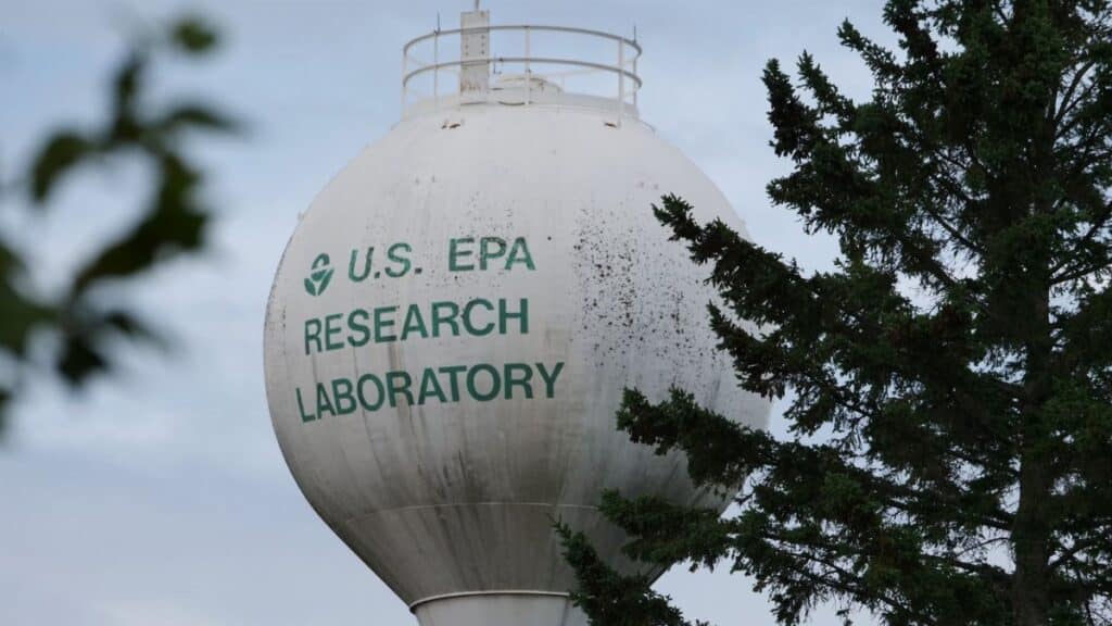 U.S. EPA Research Laboratory water tower with trees in view.