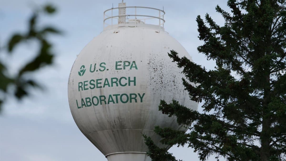 U.S. EPA Research Laboratory water tower with trees in view.