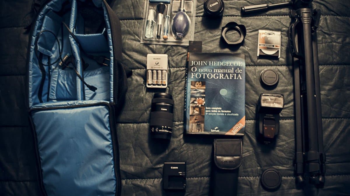 A flat lay of essential camera equipment and accessories for photography.