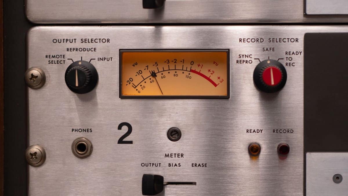 Detailed view of a vintage audio panel with dials and VU meter for recording settings.