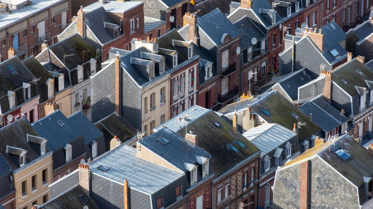 Charming rooftop architecture of Le Tréport, France, viewed from above in a sunny setting.