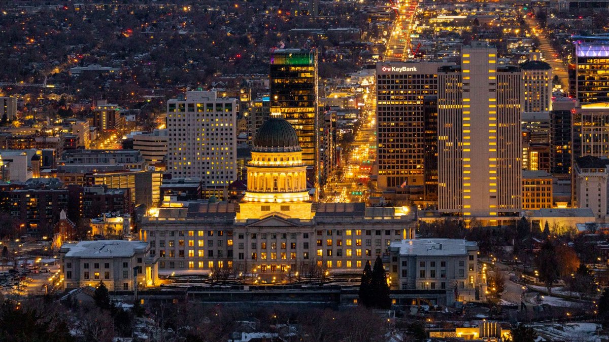 Stunning aerial view of Salt Lake City skyline featuring the Utah State Capitol illuminated at night.
