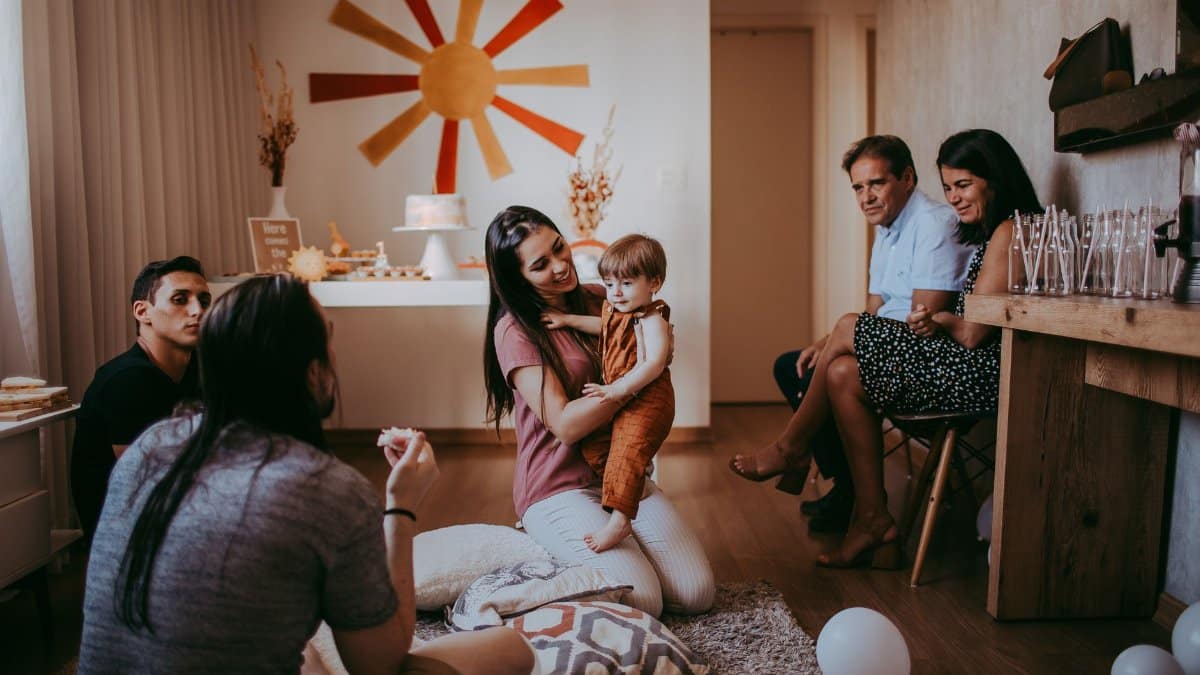 Warm family gathering in a cozy room with playful interactions and festive decorations.