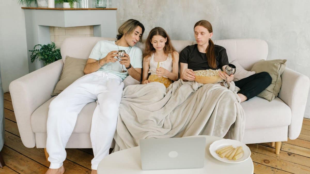 A family enjoys a cozy movie night with snacks and drinks, creating warm memories.