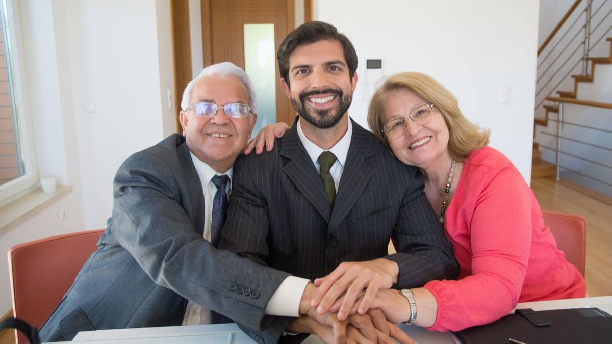 A joyful family embracing around a desk, symbolizing support and teamwork.