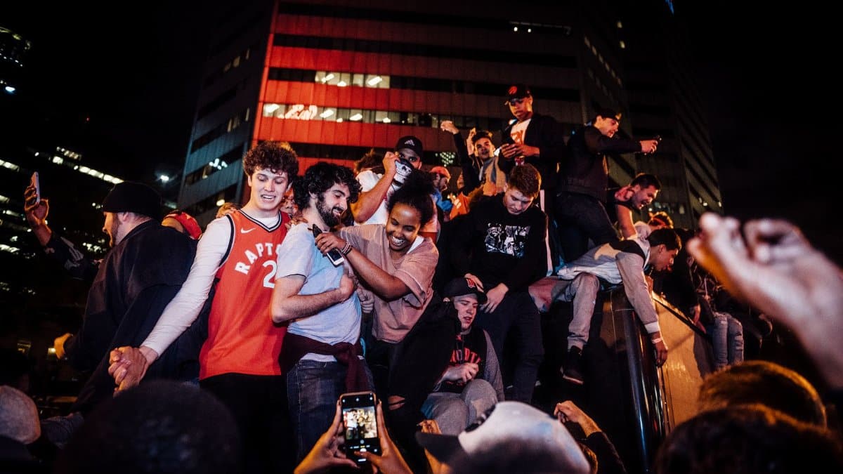 Energetic crowd celebrating a night event in the city with joyful togetherness.