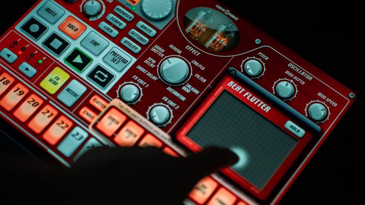Close-up of a finger interacting with a music production app on a tablet, showcasing vibrant controls.