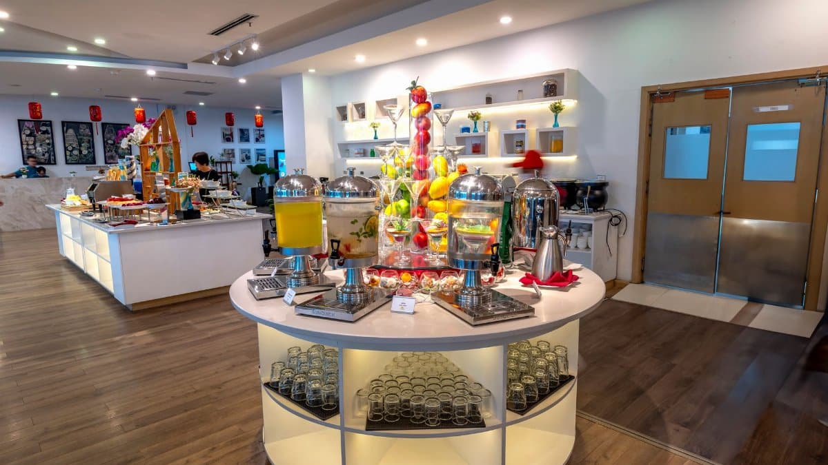 Luxurious buffet display with diverse food and beverages in a modern hotel setting.