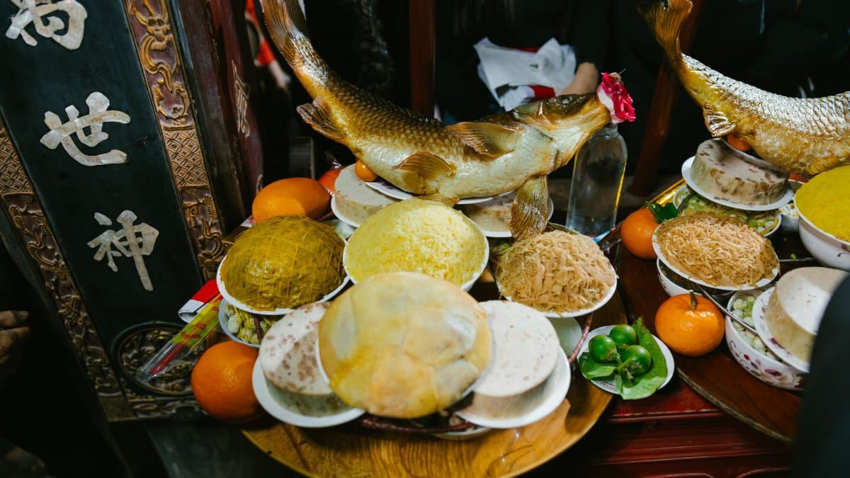 A vibrant display of traditional Asian food offerings including fish, fruits, and sweets, during a cultural festival.