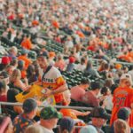 Packed Houston stadium featuring enthusiastic baseball fans during a major league game.