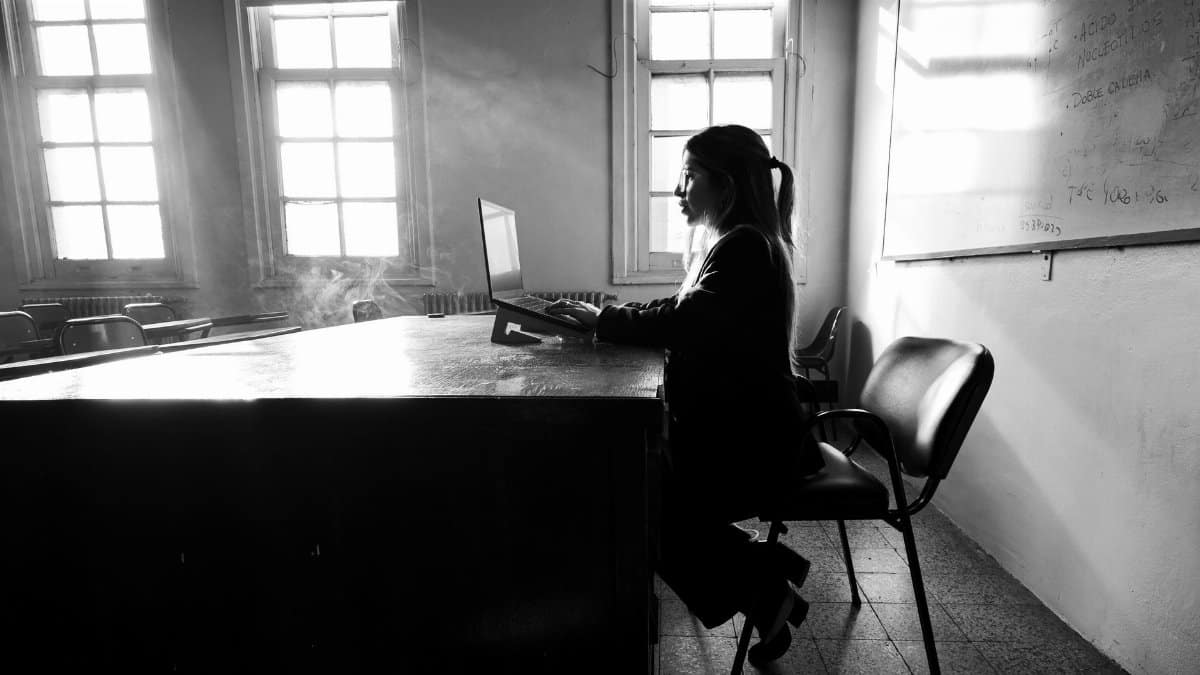 A student working on a laptop in a university classroom, Buenos Aires.