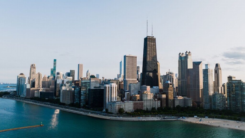 Stunning aerial view of Chicago's skyline with iconic skyscrapers along the lakeshore at dusk.