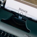 A vintage typewriter with a paper titled 'News', symbolizing journalism and communication.