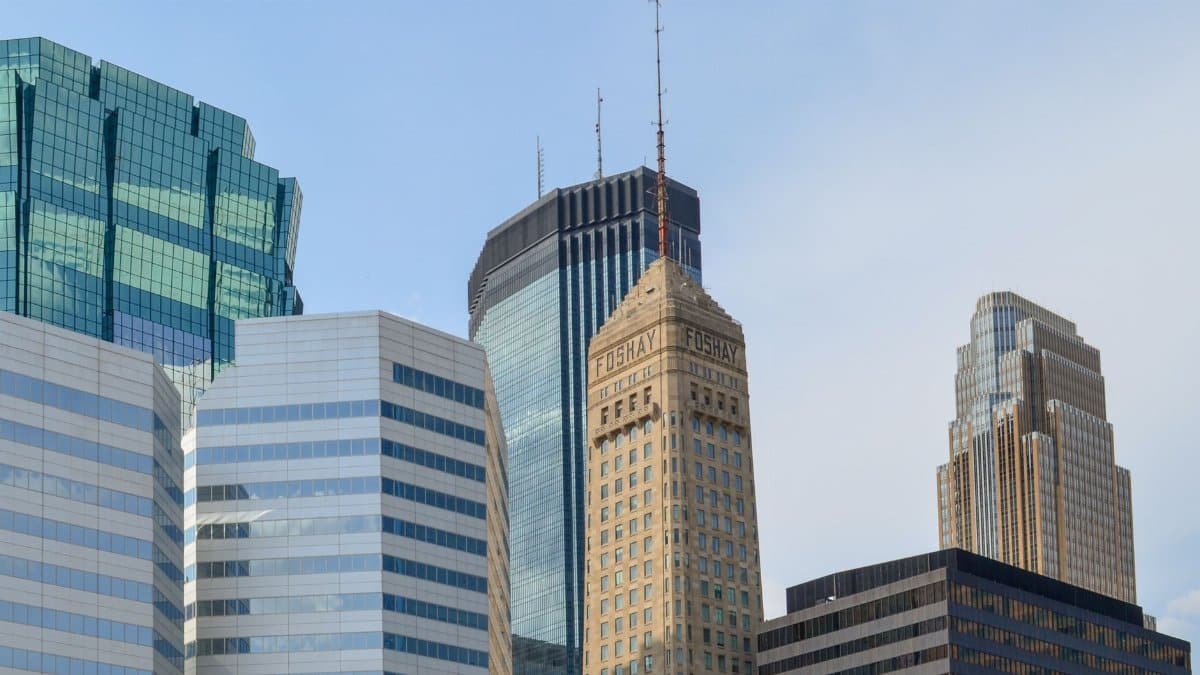 A stunning view of the Minneapolis skyline featuring prominent skyscrapers against a clear blue sky.